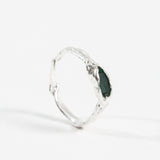 Side profile of the sterling silver Refuge Ring showing the organic handmade band and raw emerald.