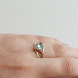 Aquamarine silver ring worn on the hand, showing its natural shine and organic setting.