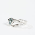“Profile view of the aquamarine ring highlighting the textured silver band.