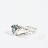 “Profile view of the aquamarine ring highlighting the textured silver band.