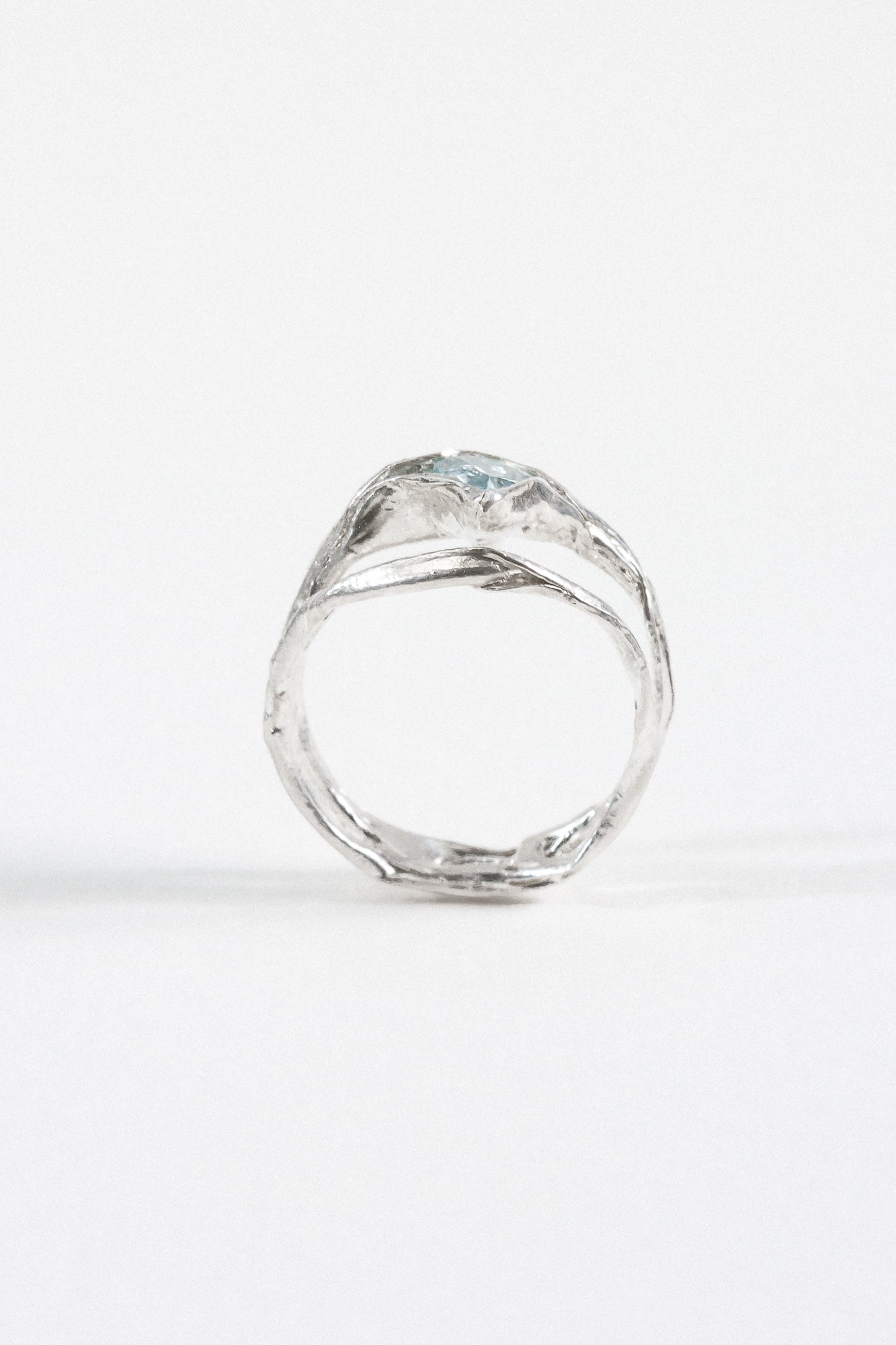 Rear view of the aquamarine ring, showcasing the organic form of the silver band