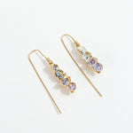 Gold-plated brass Azahar Earrings with lavender details, organic design, and elongated shape on a white background.