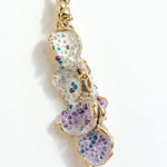 Close-up detail of the textured, hand-painted design of the Azahar Earrings in lavender tones.