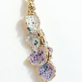 Close-up detail of the textured, hand-painted design of the Azahar Earrings in lavender tones.