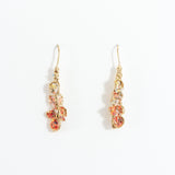 Azahar Earrings in gold-plated brass with red details, botanical design, and handcrafted finish, on a white background.