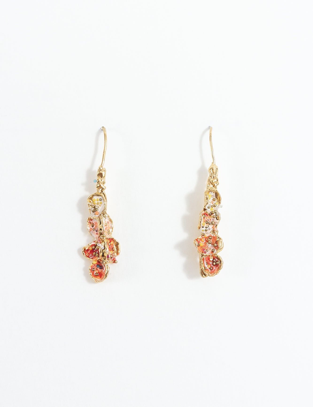 Azahar Earrings in gold-plated brass with red details, botanical design, and handcrafted finish, on a white background.