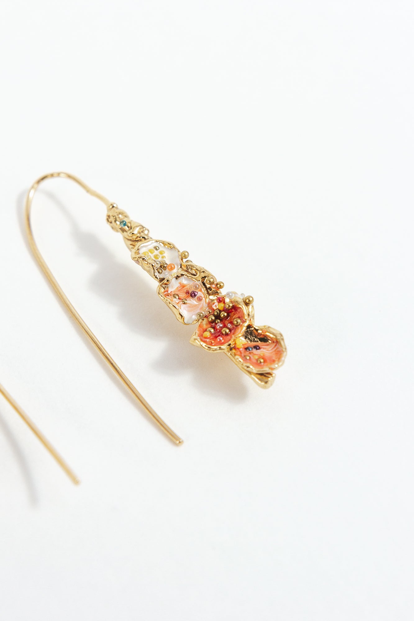 Side detail of the Azahar Earrings in red, showing their texture and organic shape.