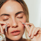 Close-up of model showing Azahar Earrings in a soft, natural setting.