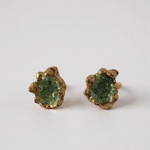 Pair of Topos Coca S stud earrings with green glass granulation and paint in scalloped gold-tone bezels, displayed on a white background.