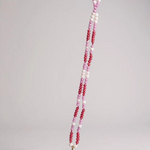 Daisy necklace displayed flat, with golden flower pendant and pink, fuchsia, and white crystal chain.