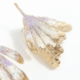 Flower Wing Earrings photographed close up, showing glass pearls and handcrafted finish