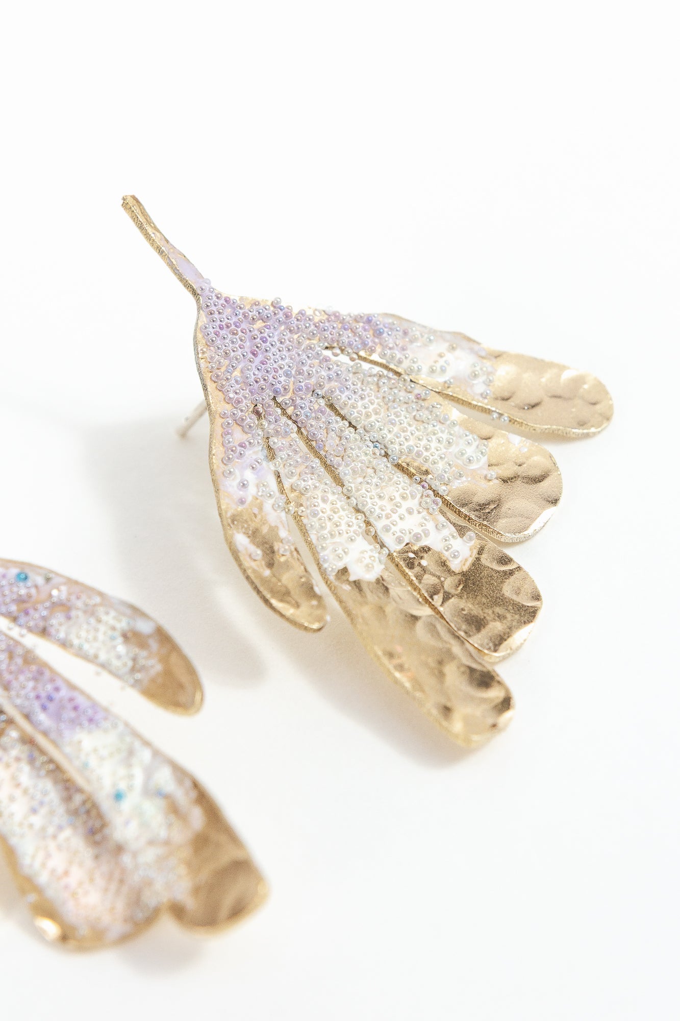 Flower Wing Earrings photographed close up, showing glass pearls and handcrafted finish