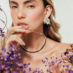 Portrait of a model wearing Flower Wing Earrings, an artistic design inspired by petals