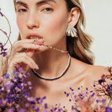 Portrait of a model wearing Flower Wing Earrings, an artistic design inspired by petals
