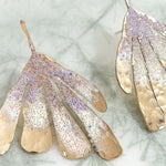 Lavender Flower Wing Earrings photographed close up, showing glass pearls and handcrafted finish.