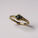 Side-angled view of the 10k yellow gold ring with a salt-and-pepper diamond, showing the organic sculpted band.