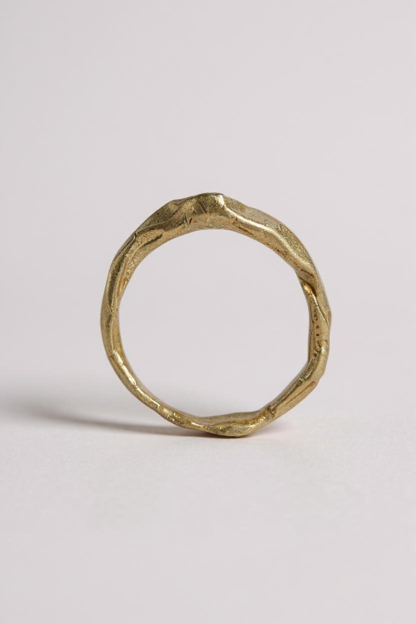 Back view of the 10k yellow gold salt-and-pepper diamond ring highlighting the handmade textured band.