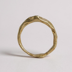 Back view of the 10k yellow gold salt-and-pepper diamond ring highlighting the handmade textured band.