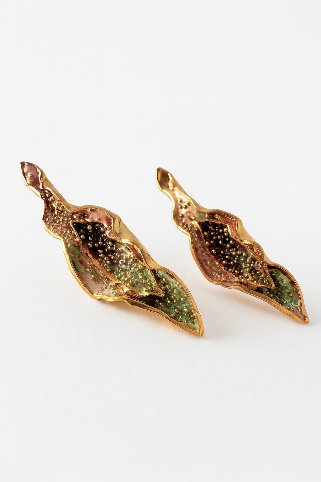 “Pair of Lettuce Leaf Earrings in gold-plated brass hand-painted  rust—with glass granulation detail, displayed on a white background.