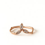 14k rose gold Marqueza ring with marquise-cut zircons on an organic sculpted band, shown front-facing on a white background.
