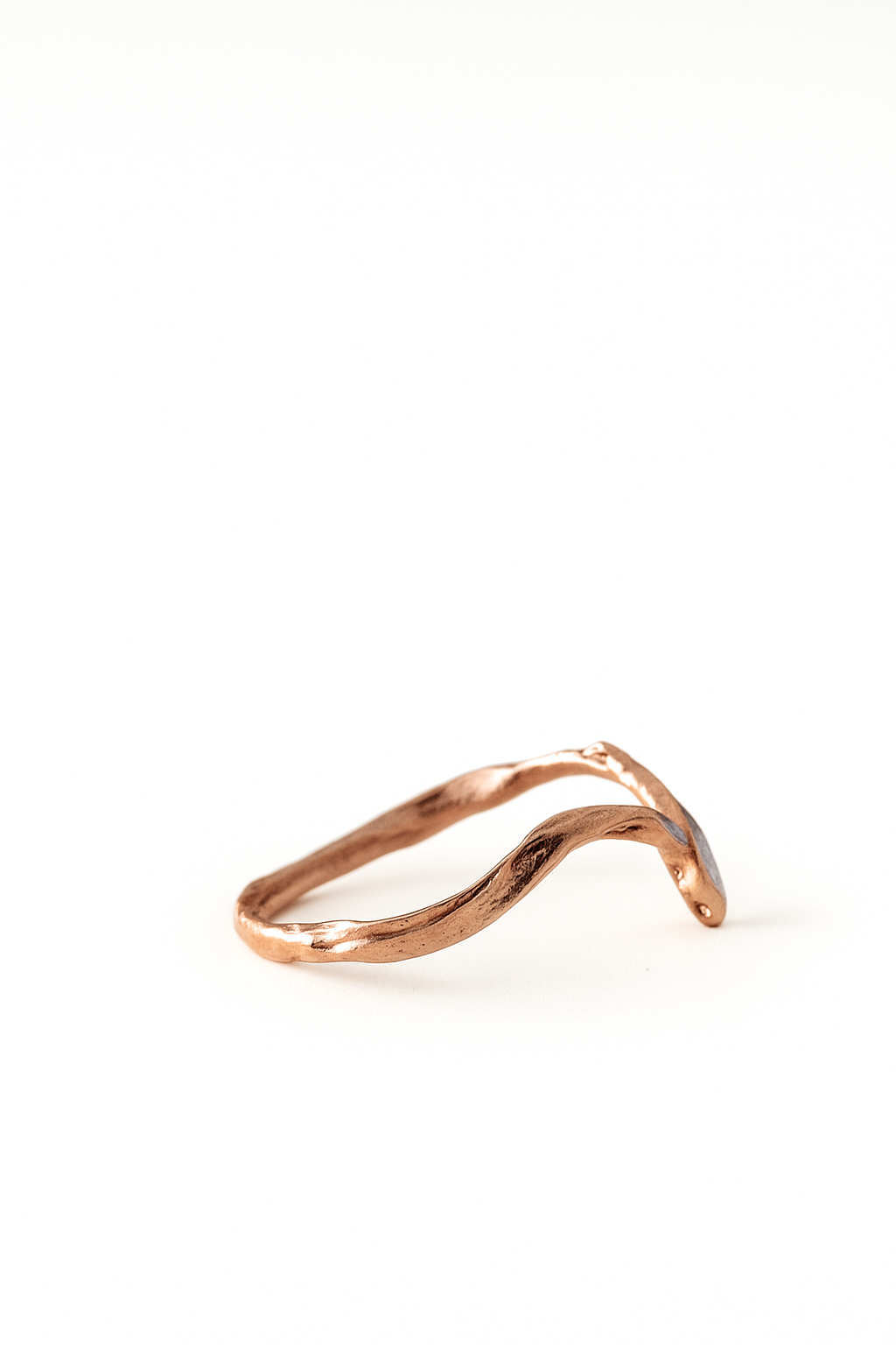 Side view of the rose gold Marqueza ring displaying its sculpted band and marquise-cut zircon setting.