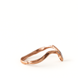 Side view of the rose gold Marqueza ring displaying its sculpted band and marquise-cut zircon setting.