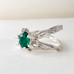 Angled side view of the sterling silver ring with lab-grown emerald, highlighting the textured handmade band.
