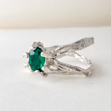Angled side view of the sterling silver ring with lab-grown emerald, highlighting the textured handmade band.