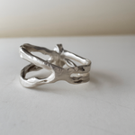 Side view of the lab-grown emerald ring showing the organic split-band design in polished sterling silver.