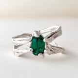 Top-down view of the sterling silver ring featuring a lab-grown emerald and sculpted organic band.