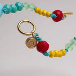 colored bead necklace with gold clasp on a light background.