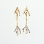 Gold-plated brass Root earrings with hand-painted lavender tips and glass granulation on a white background.