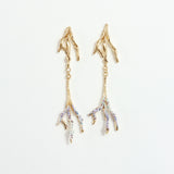 Gold-plated brass Root earrings with hand-painted lavender tips and glass granulation on a white background.