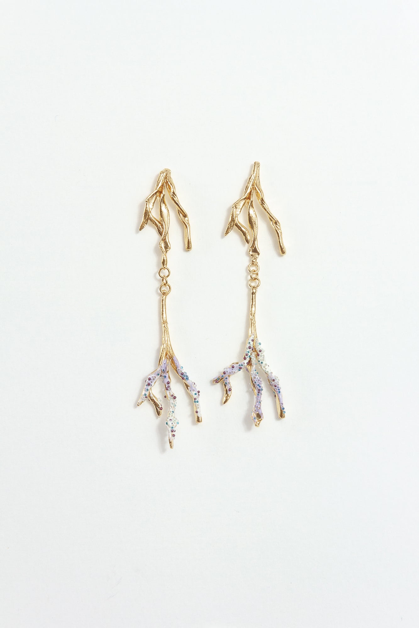 Gold-plated brass Root earrings with hand-painted lavender tips and glass granulation on a white background.