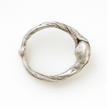 Top view of the handcrafted sterling silver ring showing its textured organic band.