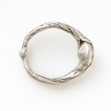 Top view of the handcrafted sterling silver ring showing its textured organic band.