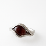 Close-up of the sterling silver ring featuring an oval sunstone set organically in the band, captured from above.