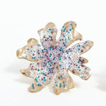 Close-up detail of the Wild Clover stud earrings, showing the textured surface and multicolored glass granulation.