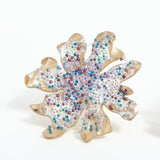 Close-up detail of the Wild Clover stud earrings, showing the textured surface and multicolored glass granulation.