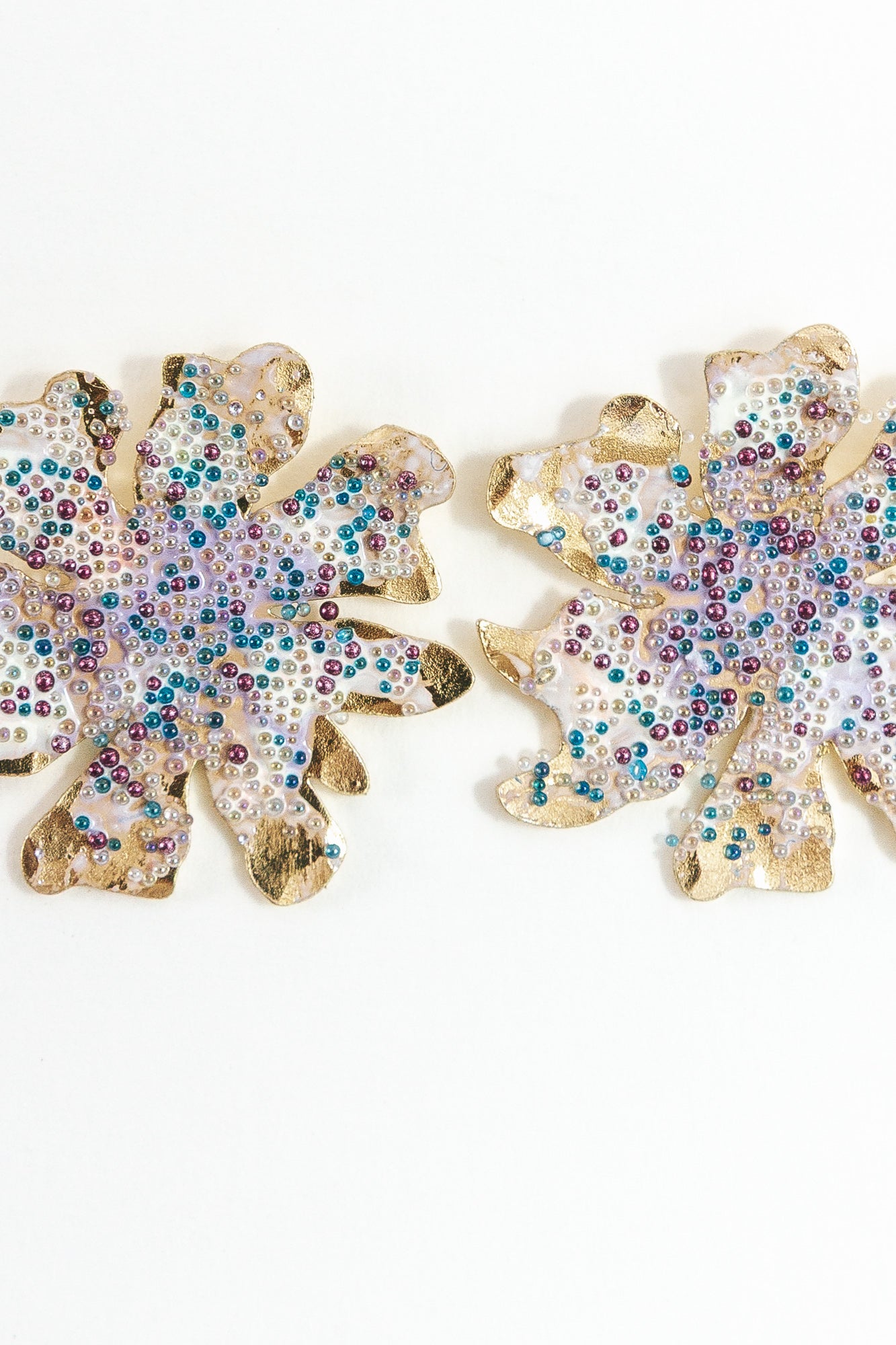 Pair of gold-plated brass Wild Clover stud earrings, viewed from the front against a white background, showing their floral shape.
