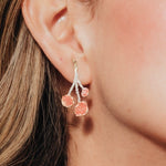 Close-up of the model wearing a agraz Earring, showcasing its botanical design and handcrafted finish.