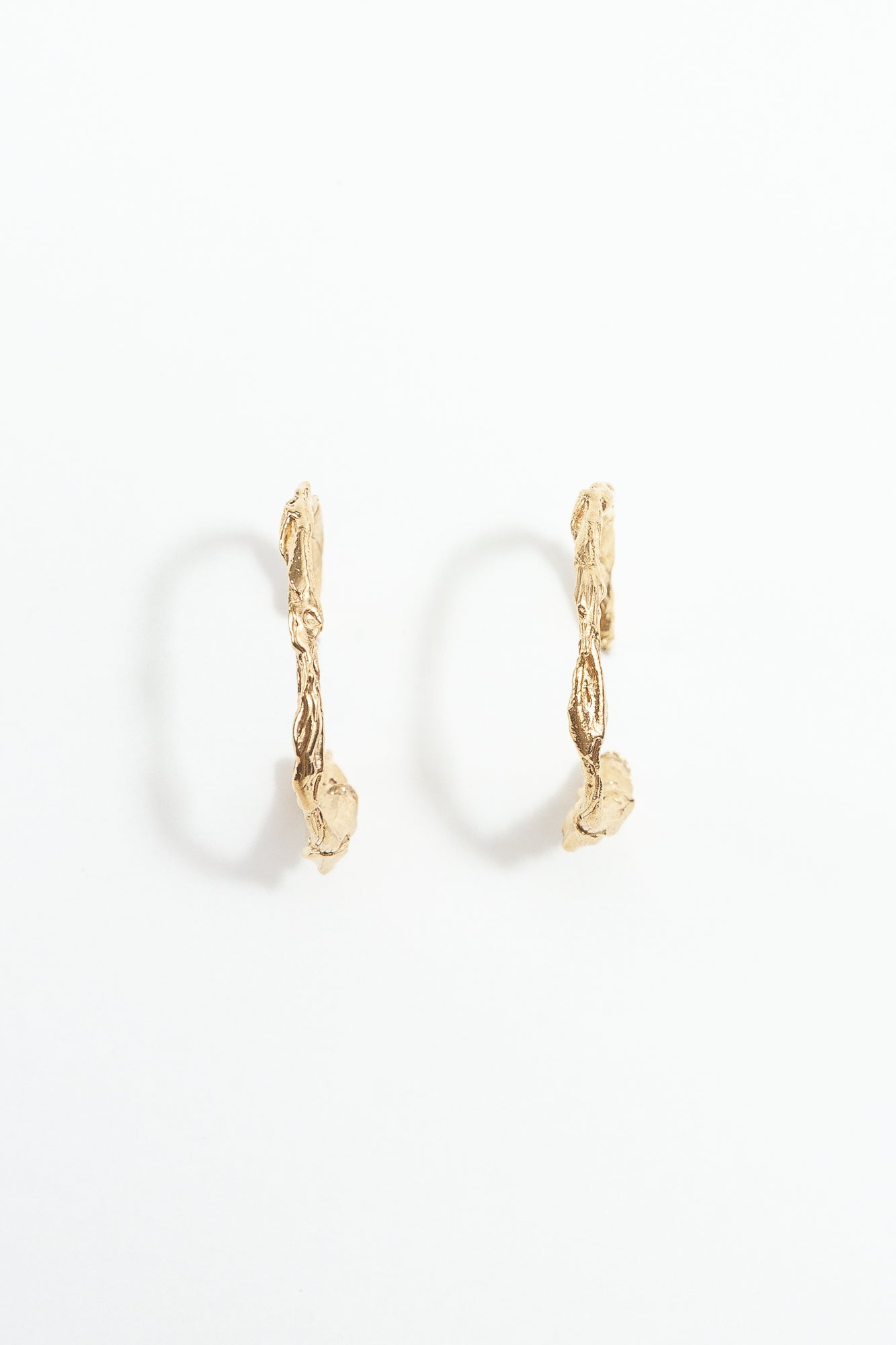 Gold hoop earrings on a white background
