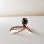 14k rose gold ring with a salt-and-pepper diamond in an organic sculpted band, shown front-facing on a white surface.