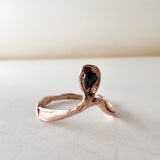 14k rose gold ring with a salt-and-pepper diamond in an organic sculpted band, shown front-facing on a white surface.