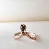 Angled close-up of the salt-and-pepper diamond set in a 14k rose gold ring, emphasizing the rustic texture and sparkle.