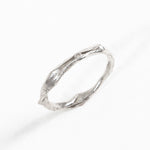 Angled view of the sterling silver Nest Ring with a lab-grown diamond highlighting its handcrafted texture.