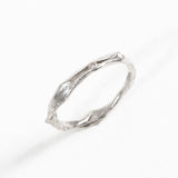 Angled view of the sterling silver Nest Ring with a lab-grown diamond highlighting its handcrafted texture.