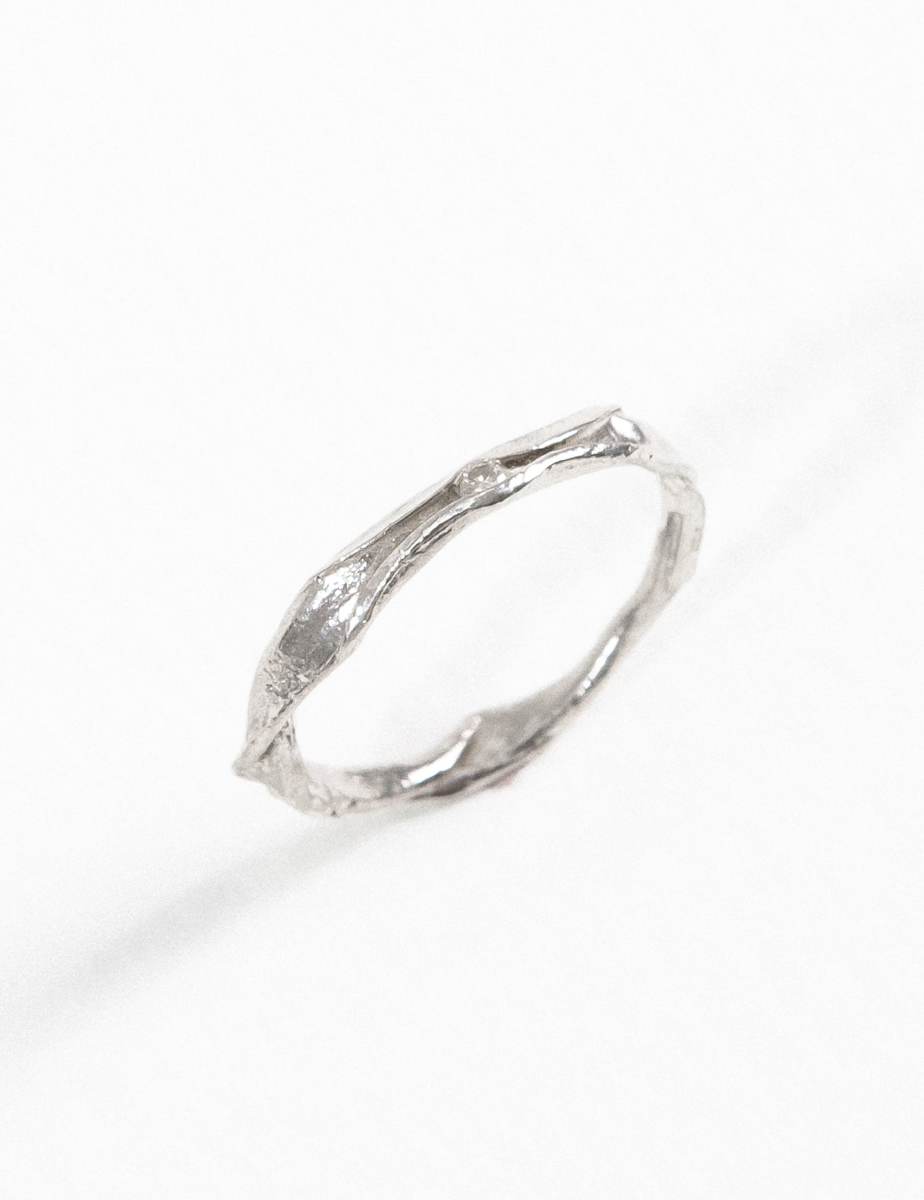 Angled view of the sterling silver Nest Ring with a lab-grown diamond highlighting its handcrafted texture.