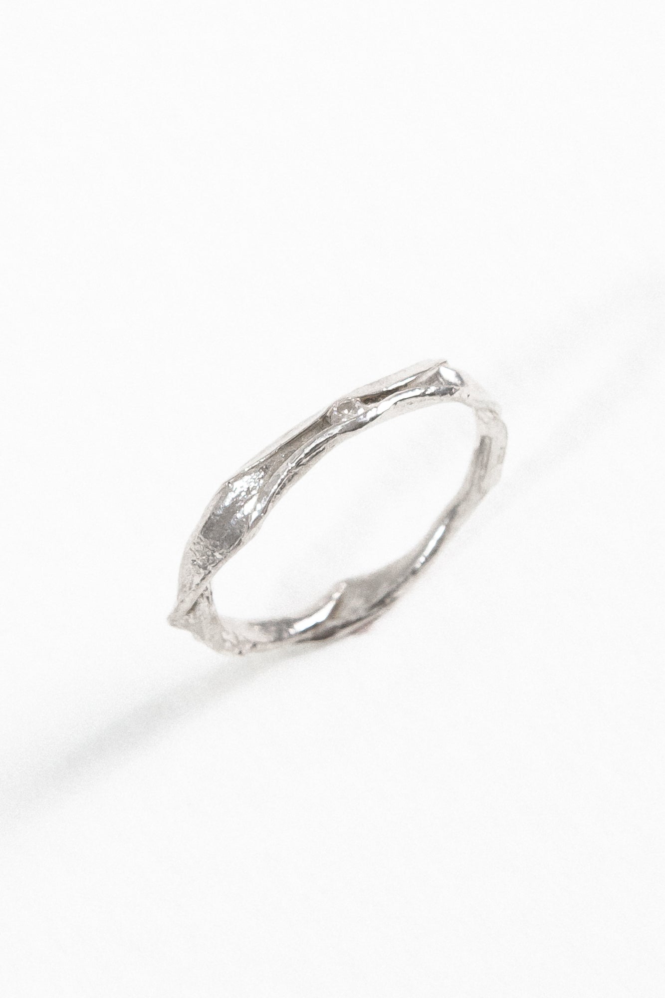 Angled view of the sterling silver Nest Ring with a lab-grown diamond highlighting its handcrafted texture.