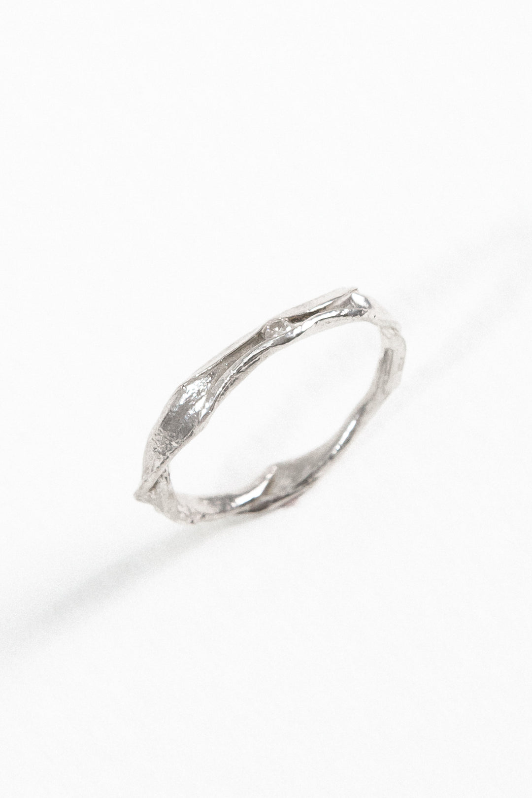 Angled view of the sterling silver Nest Ring with a lab-grown diamond highlighting its handcrafted texture.